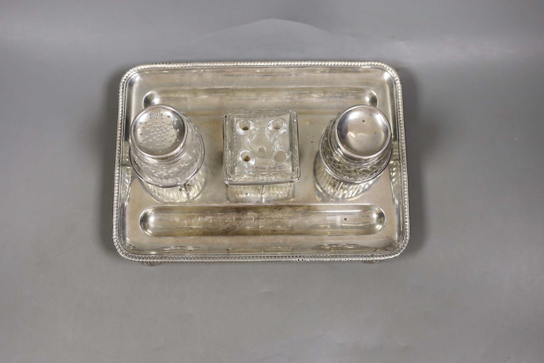 A George III silver rectangular inkstand, with three mounted cut glass wells, Matthew Bolton, Birmingham, 1807, 22.5cm, 13.5oz.